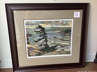 Framed print showing whole artwork, mat, and frame, depicting a rugged coastal scene with waves and trees under cloudy skies.