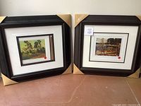 Two framed prints by Tom Thomson with protective corner coverings on frames, showing overall lot condition.
