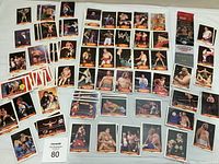WWF trading cards laid out showing various individual wrestler portraits and action shots with WWF logos and names clearly visible, plus a sealed UFC Topps trading card pack.