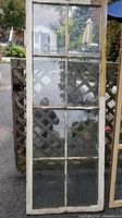 Antique wooden window with six glass panels, aged wood, and original glass
