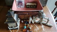 Full lot on table showing wood baskets, Noel sign with owl, Peace sign, metal snowflake candle base, Yule jewel ornaments, and small lantern.