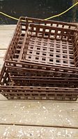 Stack of brown lattice pattern heavy metal boxes varying in size, showing the design and condition.