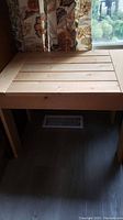Front view of rectangular pine table showing the full piece and surrounding area