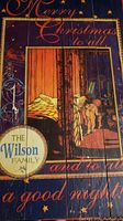 Full view of the wooden Christmas sign showing the full vintage indoor Christmas scene and text including 'The Wilson Family' emblem.