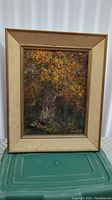 Front view of antique framed oil painting featuring a textured autumn tree scene signed by Phoebe C.