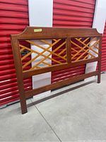Full front view of vintage wood headboard showing its rectangular shape and lattice design.
