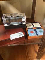 Altec Lifejacket Jolt Bluetooth speaker in display box, boxed card sets on wooden surface