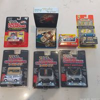 Full view of all seven diecast vehicles in original packaging on flat surface.