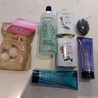 Full lot displayed: bag of 8 Vanilla Brulee bath bombs, two bottles of Vitabath body wash, 1 liter Vitabath bubble bath, two tins of Yardley perfumed body powders (Lavender and English Rose), exfoliating bar, boxed Original Make Up Eraser sheet.