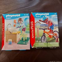 Two Playmobil boxed sets 70301 and 70303 side by side, showing front packaging and age recommendations.
