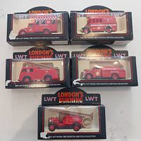 Lot of 5 Lledo London's Burning diecast firetrucks in original boxed packaging, showing various models grouped together.