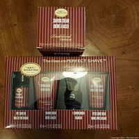 Front view of The Art of Shaving 4 Elements of the Perfect Shave kit with sandalwood essential oil, showing pre-shave oil, shaving cream, brush, after-shave balm in packaging along with separate boxed 150ml shaving cream.