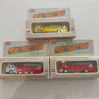 Three Model Power Fire Fighters diecast HO scale firetrucks in original blister card packaging, showing front and top boxes.