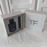 Open gift set box with Tom Ford TF logo and two items displayed