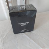 Front and side of black box labeled Tom Ford Noir Eau de Parfum 50ml, cellophane sealed.
