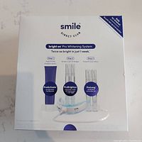 Front photo of sealed Smile Direct Bright On Pro Whitening System box showing included items and branding.