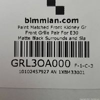 Label showing brand website, part description as paint matched front kidney grille pair for E30 with matte black surrounds and slats, part number GRL30A000.