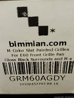 Label showing 'bimmian.com' M-Color slat painted grilles for E60 front grille pair, gloss black surrounds, part GRM60AGDY.