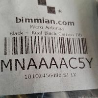 Label from packaging showing brand bimmian.com, model MNAAC5Y. Describes item as Micro Antenna Black + Real Black Carbon Fiber.