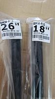 Two windshield wiper blades in original plastic packaging, labeled BMW F10 26 inches and 18 inches.