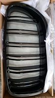 Single BMW F10 M5 black front grill with vertical slats, glossy finish, inside protective packaging foam.
