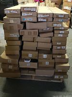 Stacked boxes of automotive parts on a pallet.