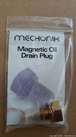 Sealed plastic bag containing a Mechünik branded Magnetic Oil Drain Plug with packaging insert.