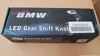 Box front showing BMW branding and LED Gear Shift Knob product name with no OBC error indication.