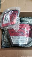Two LED rear lens lights for BMW E46 coupe 2000-2003 packed inside a box in plastic bags.
