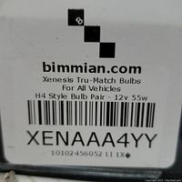 Close-up of box label showing brand Xenesis, product name Tru-Match Bulbs, H4 style bulb pair 12v 55w and barcode with code XENAAA4YY