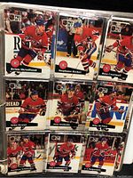 Photo showing hockey cards from Montreal Canadiens players in clear plastic binder sleeves.