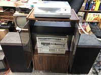 Overall setup showing turntable on cabinet, stacked JVC components and speakers