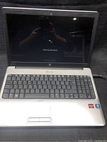 Photo of HP laptop screen showing Windows starting screen.