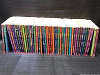 Full view of 46 Goosebumps books arranged side by side showing colorful spines.