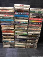 Front view of the stacked cassette tapes showing titles and artists clearly for identification.