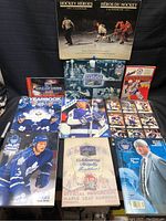 Photo of entire collection showing a variety of books, yearbooks, postcards, programs, and a calendar related to the Toronto Maple Leafs hockey team.