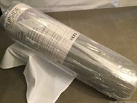Photo of ELTE FlipSide under pad roll sealed in clear plastic packaging with label visible.