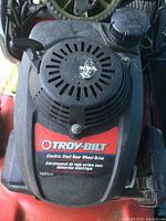 Top view of lawn mower engine cover showing Troy-Bilt label and 160cc Honda engine