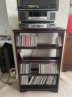 Overall view of Bose system on shelving with CDs