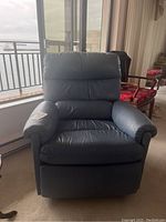 Front view of blueish grey leather recliner armchair showing padded seat, armrests, and backrest