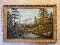 Frontal view of the signed original landscape oil painting in ornate gold frame, showing the full artwork and frame condition.