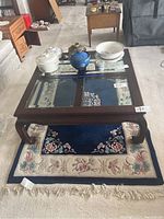 Photo showing 4x6 rug under coffee table with floral design and tassels