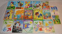 All 17 children's board puzzles laid out face up showing colorful pictures and puzzle images with popular children characters and themes