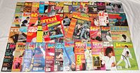 Overview photo showing approximately 50 vintage martial arts magazines fanned out with colorful covers and varied martial arts imagery dated from 1970s to 1990s.