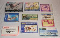 Nine vintage model kit boxes arranged flat showing brand, type, and condition gist.
