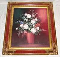 Full view of the framed floral oil painting showing the ornate frame and flower vase scene.