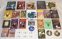 Group photo of all Harry Potter items including books, DVD, cassette audiobook, computer game CD, puzzle, sticker book, and collectible cards and pamphlets spread on a flat surface.