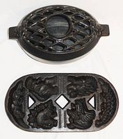 Top view showing cast iron humidifier steamer with lattice design and dinosaur muffin pan with five detailed dinosaur molds