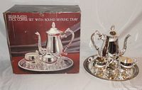 Photo of boxed set with coffee pot, sugar bowl, creamer, and serving tray displayed.