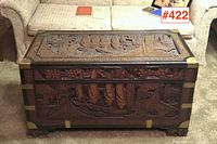 Front view showing carved sailing junk scene and brass corner guards